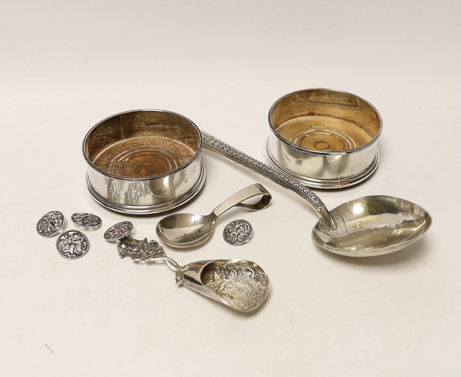 A Georg Jensen silver christening spoon, a pair of modern silver wine coasters, a set of five silver buttons and two white metal spoons, one stamped 800.